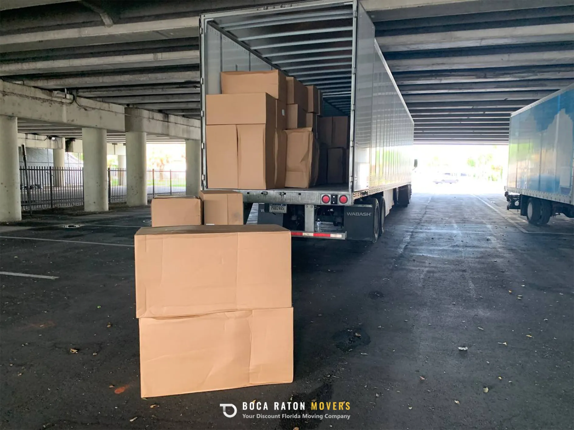 Boca Raton Movers Packed Boxes Ready for Loading in White Truck
